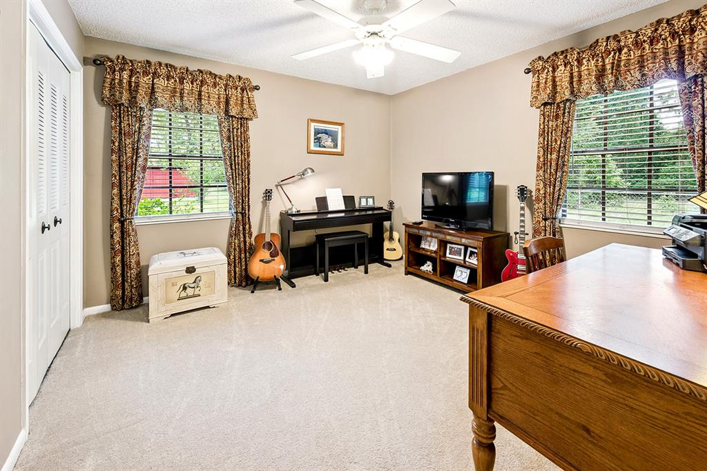 8991 Northwest 115th Street Chiefland, FL 32626 - Photo 43 of 49 a living room with furniture and a flat screen tv