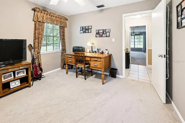 a bed sitting in a room next to a window