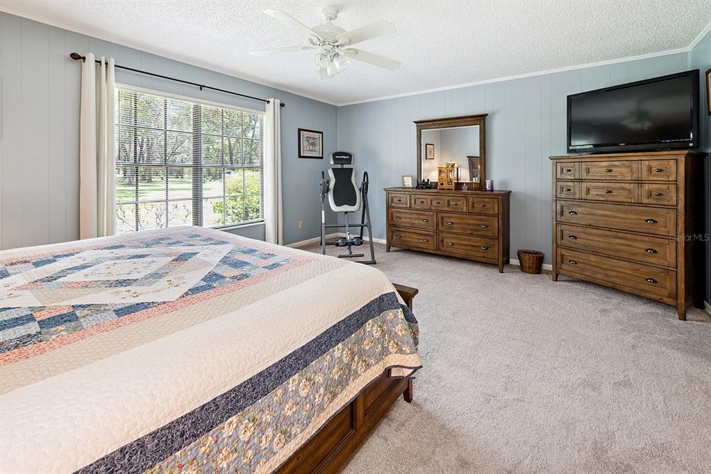 8991 Northwest 115th Street Chiefland, FL 32626 - Photo 47 of 49 a bedroom with a bed and flat screen tv