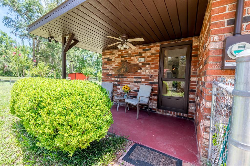 8991 Northwest 115th Street Chiefland, FL 32626 - Photo 7 of 49 a backyard of a house with outdoor seating