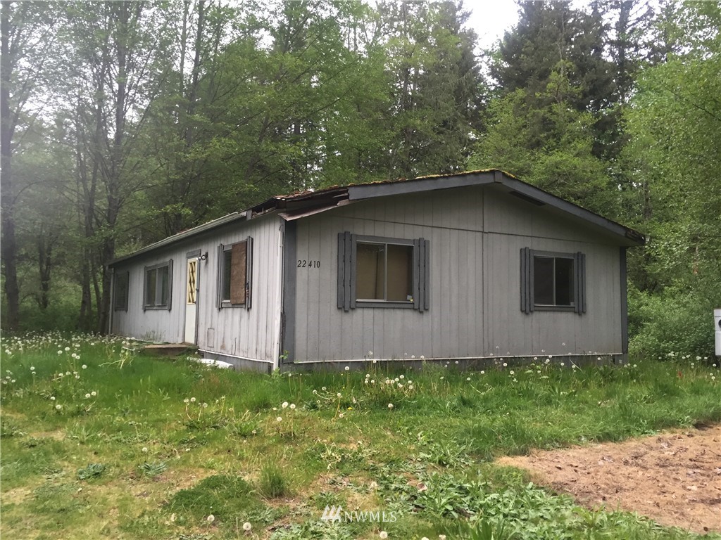 a house with green field in front of it