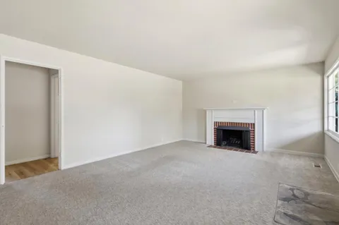a view of an empty room with a fireplace