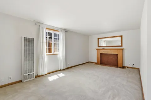 a view of a kitchen with a sink a refrigerator and a fireplace