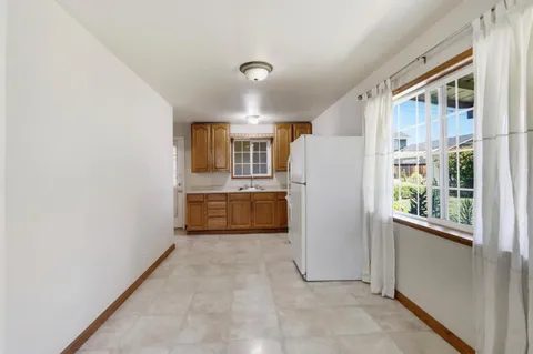 a kitchen with white cabinets and white appliances