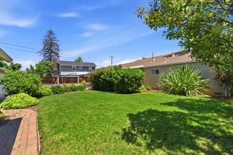 a view of a garden with a building in the background
