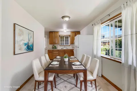 a view of a dining room with furniture and window