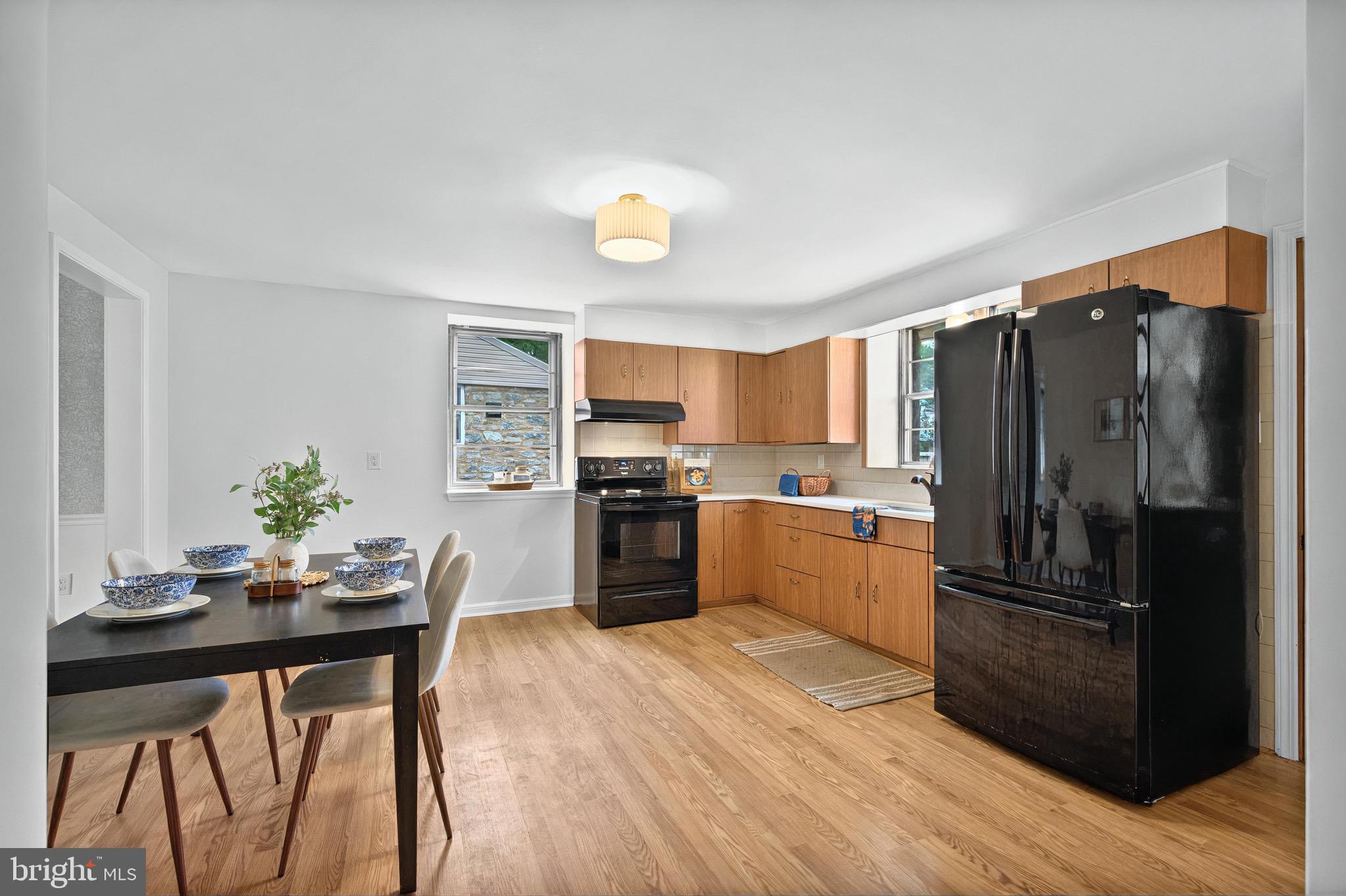 3 Arbor Lea Road Lansdowne, PA 19050 - Photo 10 of 32 a kitchen with granite countertop a refrigerator stove and wooden floor