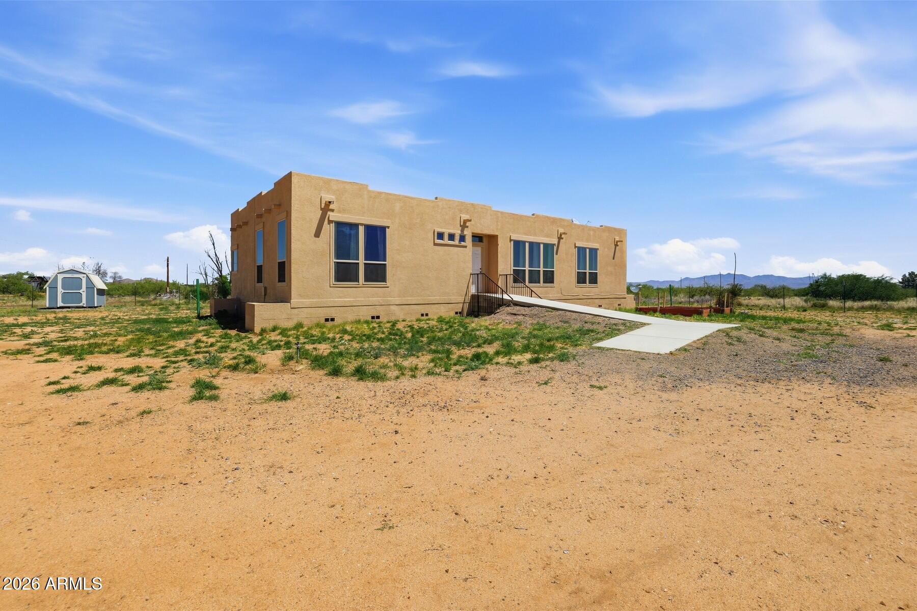 3216 North Mesquite Road Cochise, AZ 85606 - Photo 2 of 39 a front view of a house with a yard