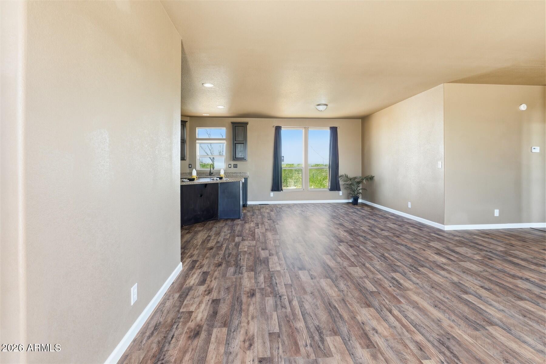 3216 North Mesquite Road Cochise, AZ 85606 - Photo 4 of 39 a view of empty room with wooden floor and fan