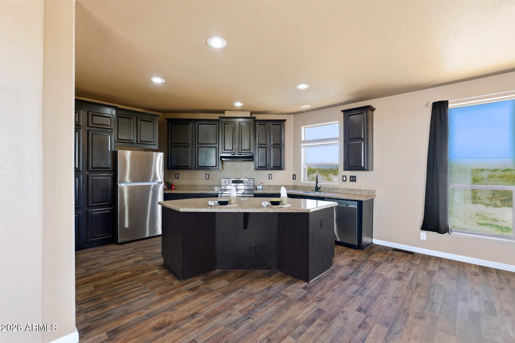 3216 North Mesquite Road Cochise, AZ 85606 - Photo 8 of 39 a kitchen with refrigerator sink cabinets and wooden floor