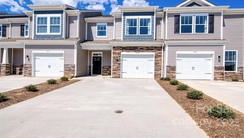 82 Creekview Road Hendersonville, NC 28792 - Photo 1 of 37 a front view of a house with a yard