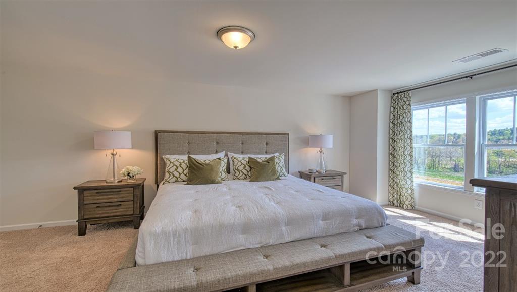 82 Creekview Road Hendersonville, NC 28792 - Photo 24 of 37 a bedroom with a bed and a large window