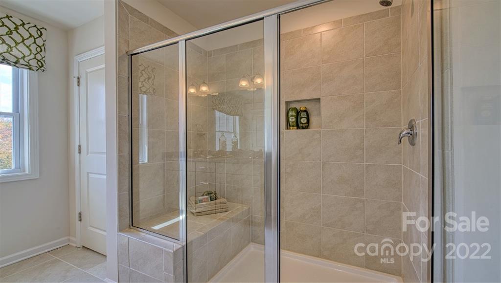 82 Creekview Road Hendersonville, NC 28792 - Photo 26 of 37 a bathroom with a glass shower door