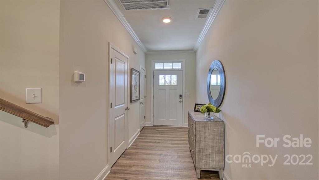 82 Creekview Road Hendersonville, NC 28792 - Photo 4 of 37 a view of a hallway with wooden floor and windows