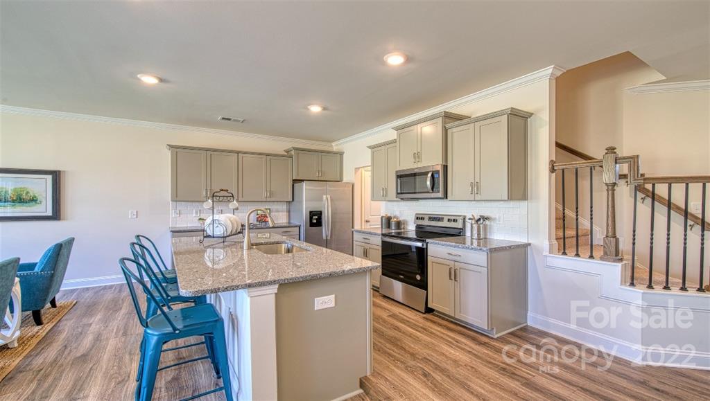 82 Creekview Road Hendersonville, NC 28792 - Photo 6 of 37 a kitchen with refrigerator a stove and chairs