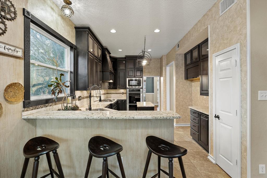 7410 Arborside Drive Rowlett, TX 75089 - Photo 14 of 39 Breakfast bar overlooks kitchen