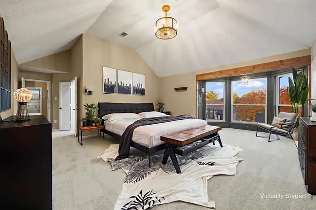 a bedroom with a bed and a large window