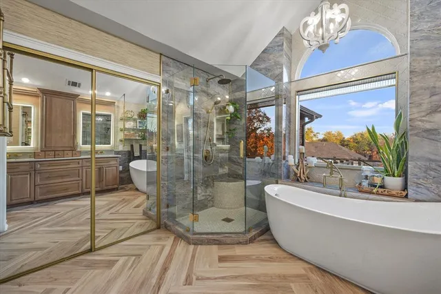 a bathroom with a sink a toilet a mirror and shower