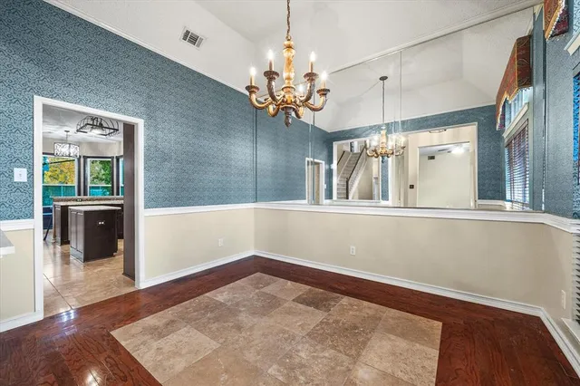 a view of a hallway with a chandelier fan and wooden floor