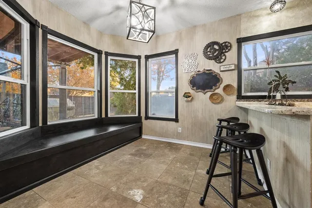 a bathroom with a window and a chandelier