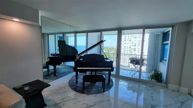 a room with a chair and a potted plant