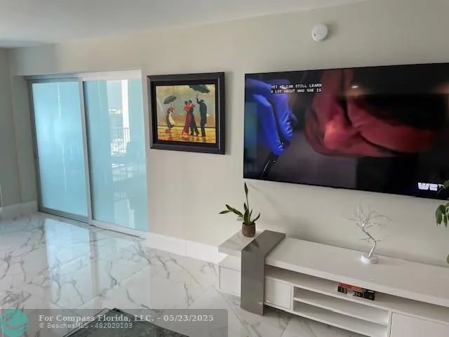 a living room with a bed and a large window