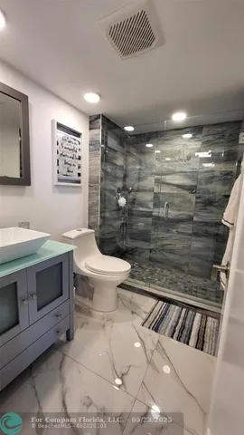 a view of a living room with furniture and a flat screen tv