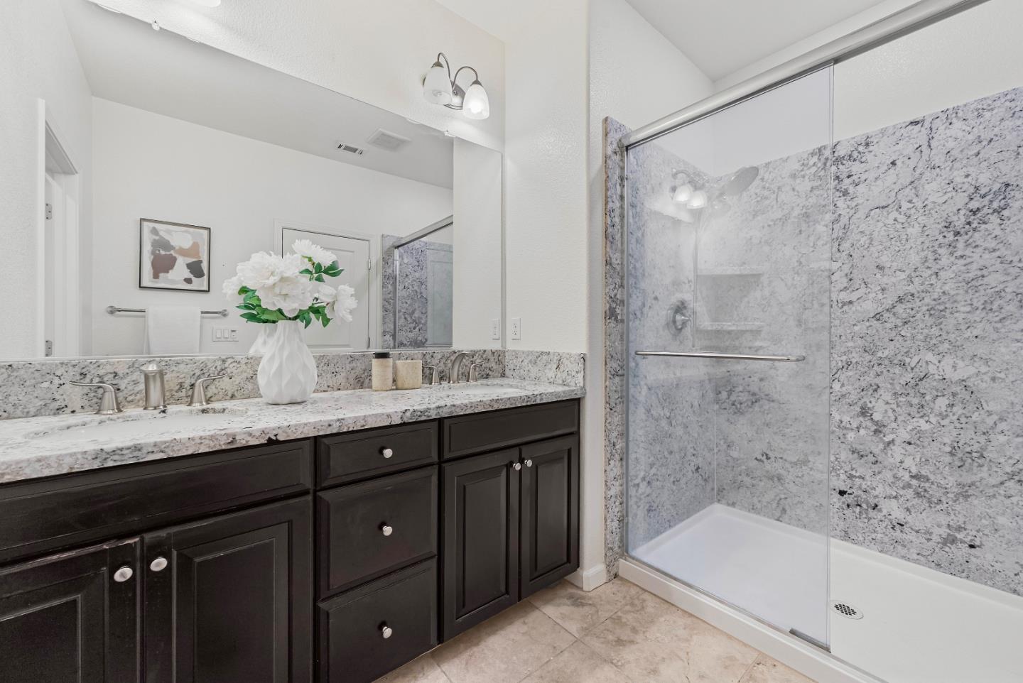 2753 Ferrara Circle San Jose, CA 95111 - Photo 21 of 46 a bathroom with a granite countertop sink mirror and a bathtub