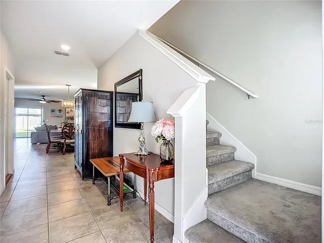 a large kitchen with stainless steel appliances lots of counter top space cabinets and furniture