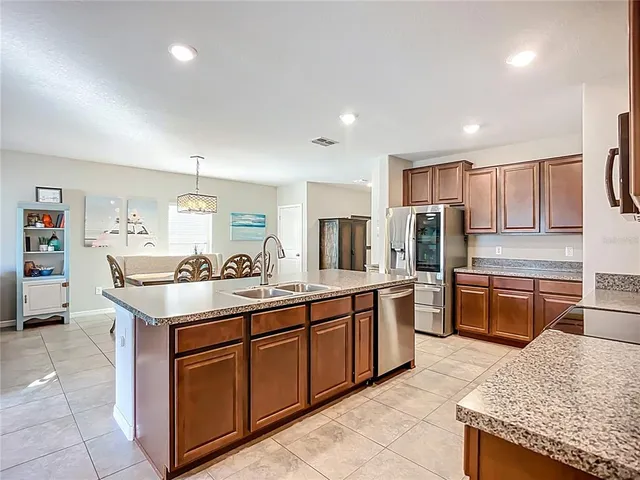 a large kitchen with stainless steel appliances lots of counter top space