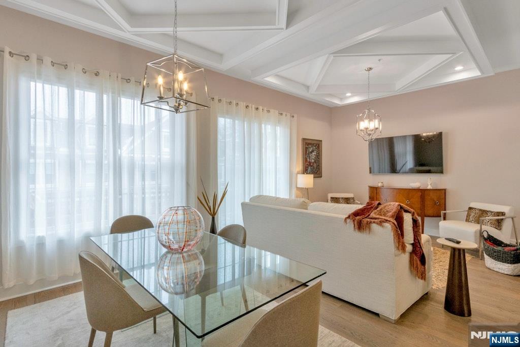 704 Opus Way, Unit 704 Montvale, NJ 07645 - Photo 11 of 33 a living room with furniture and a chandelier