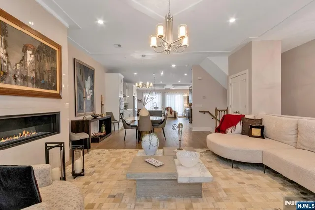 a living room with fireplace furniture and a chandelier