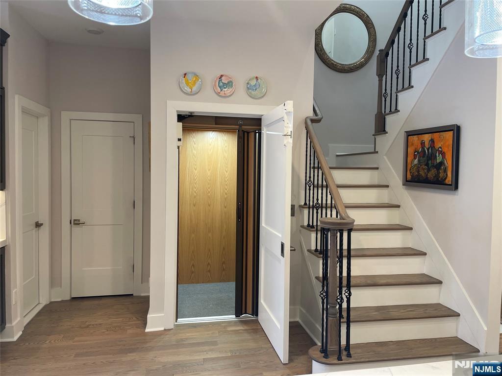 704 Opus Way, Unit 704 Montvale, NJ 07645 - Photo 13 of 33 a view of a hallway with wooden floor and entryway