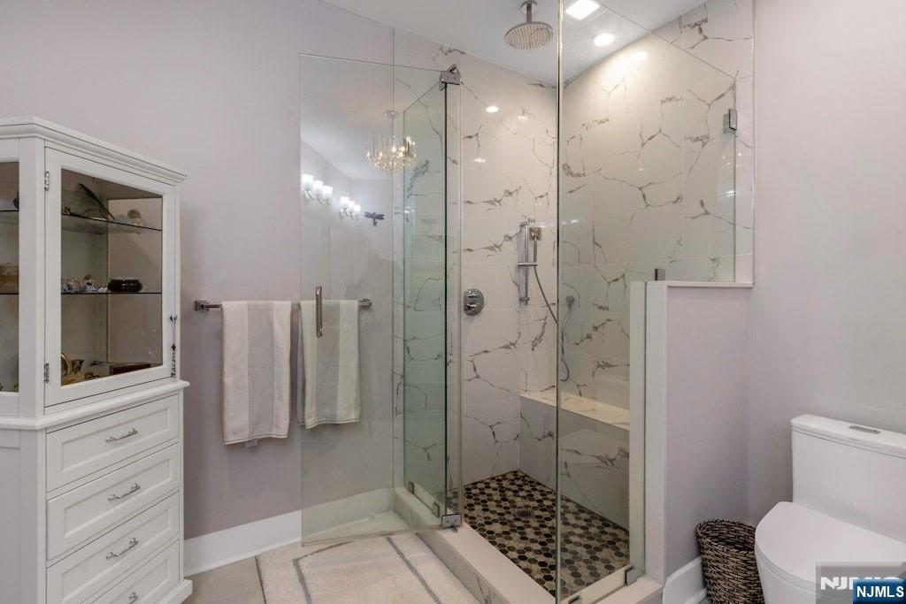 704 Opus Way, Unit 704 Montvale, NJ 07645 - Photo 18 of 33 a bathroom with a shower and a toilet