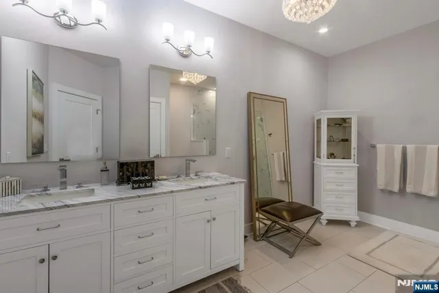 a spacious bathroom with a granite countertop sink a mirror and a