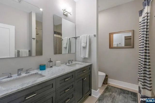 a bathroom with a double vanity sink and a mirror
