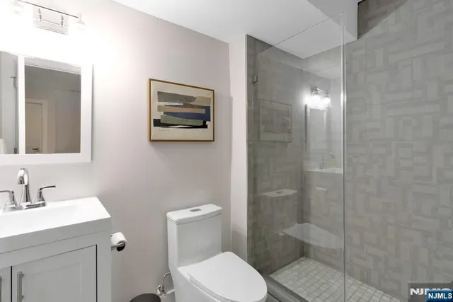 a bathroom with a toilet a sink and shower