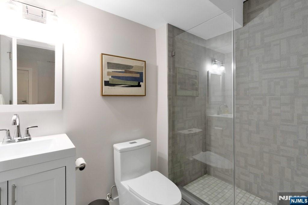 704 Opus Way, Unit 704 Montvale, NJ 07645 - Photo 26 of 33 a bathroom with a toilet a sink and shower