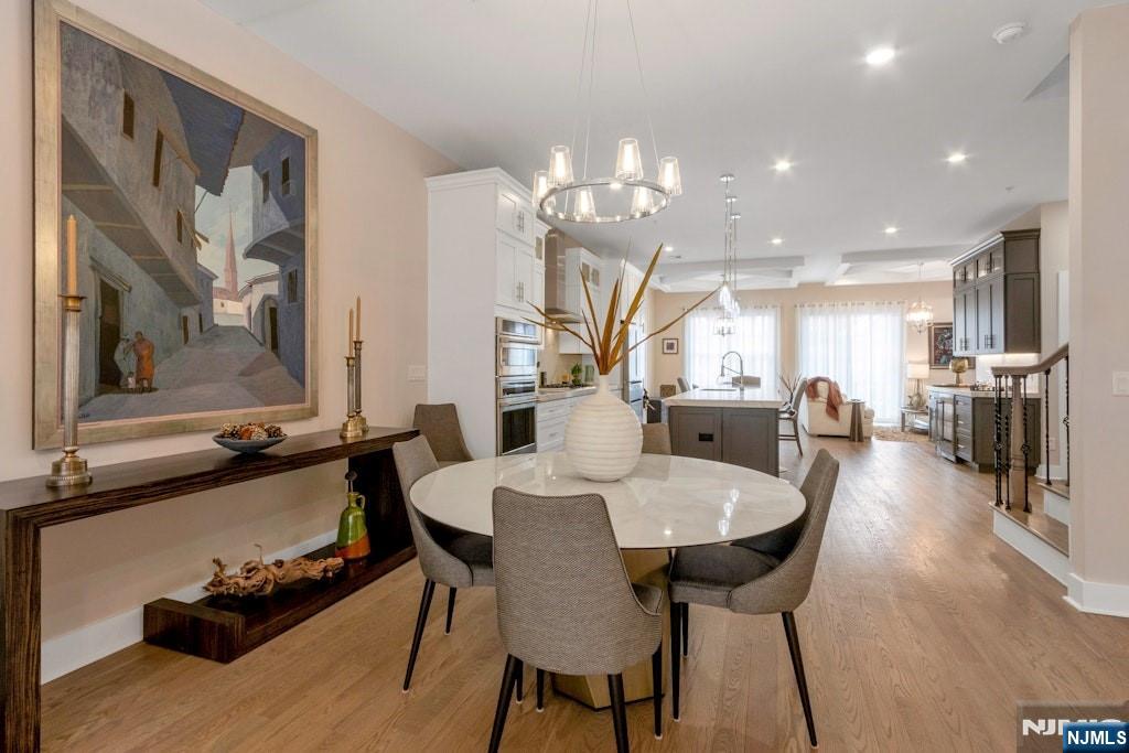 704 Opus Way, Unit 704 Montvale, NJ 07645 - Photo 5 of 33 a large kitchen with a table and chairs