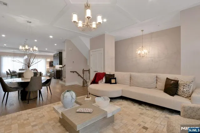 a living room with furniture and a chandelier