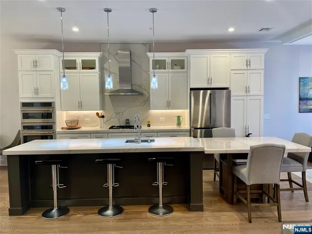 a kitchen with a table chairs refrigerator and cabinets