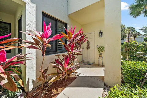 a living room with furniture a two lamps and a wooden floor