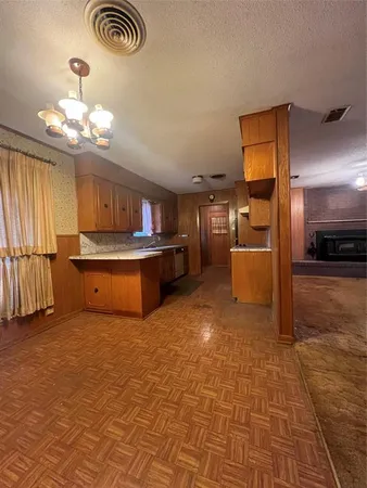 a kitchen with stainless steel appliances granite countertop a sink a stove cabinets and wooden floor