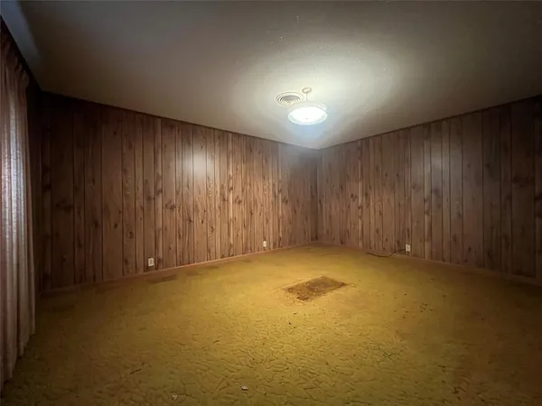 an empty room with closet and windows