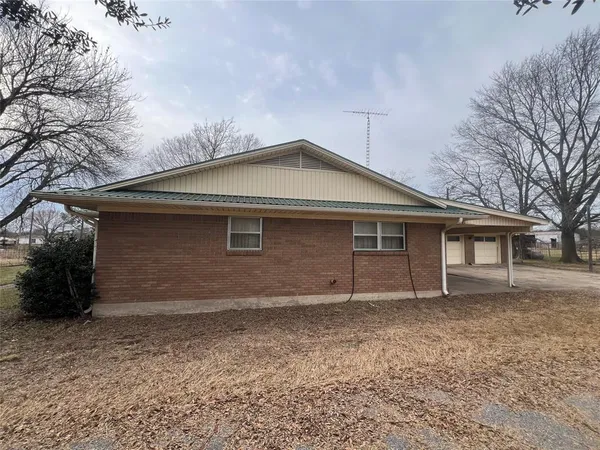 a view of a yard covered with snow in front of house