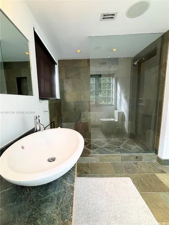 a bathroom with a tub sink and mirror
