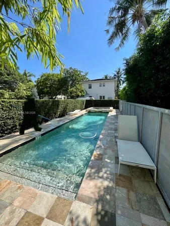 a view of a backyard with a garden and entertaining space
