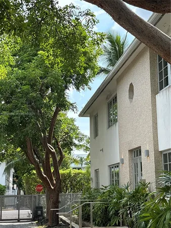 a front view of a house with plants