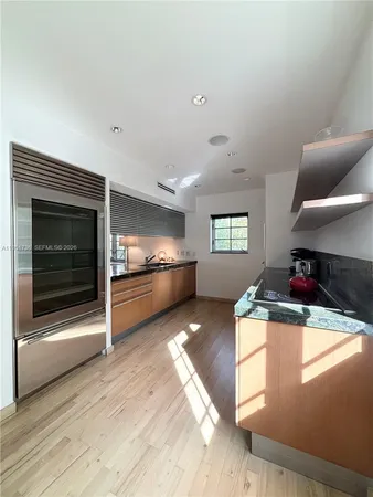 a kitchen with stainless steel appliances granite countertop a stove and a refrigerator