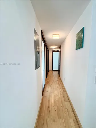 a view of hallway with wooden floor